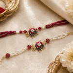 Royal maroon elephant motif Rakhi and pearl bracelet set - close-up